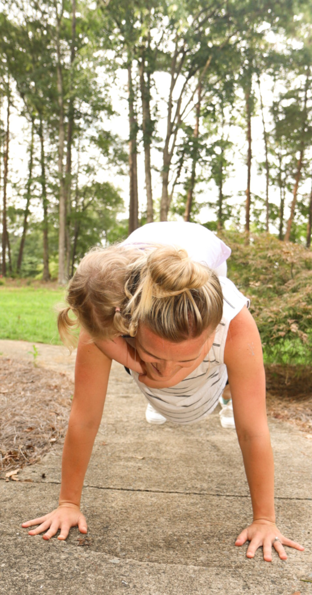 Mom exercising with a toddler on her back, healthy lifestyle